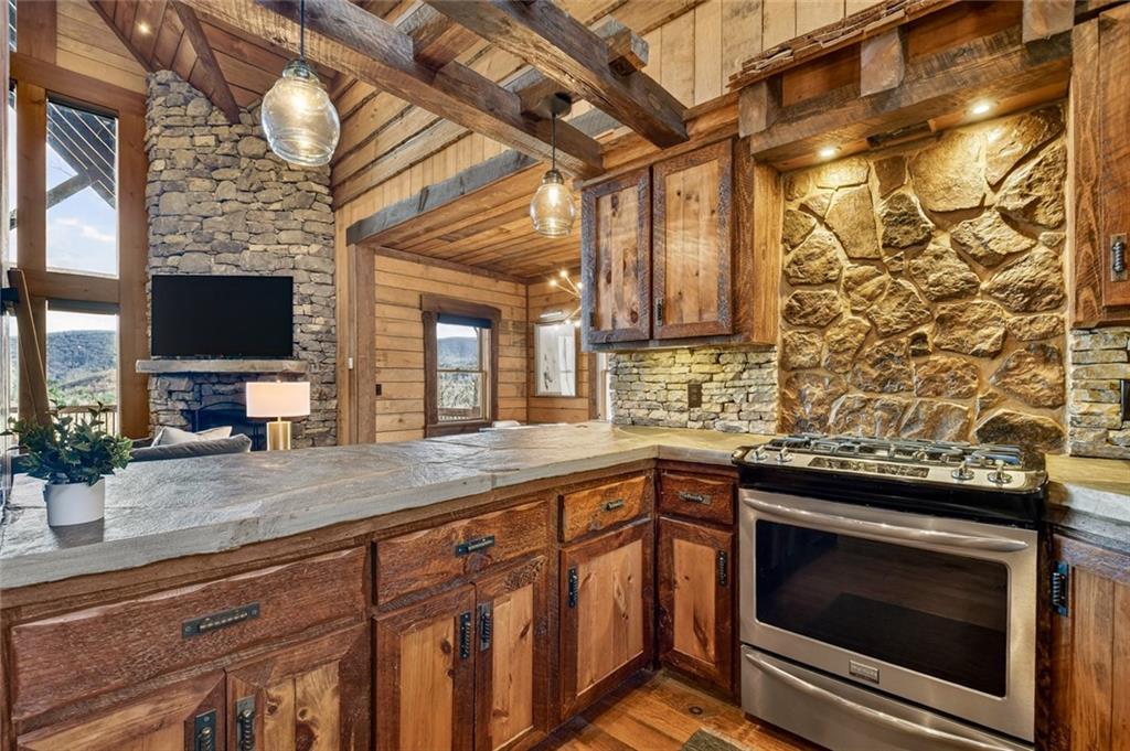 249 Settlement Road Epworth, GA 30541 - Photo 26 of 74 a kitchen with a sink and a stove next to a window