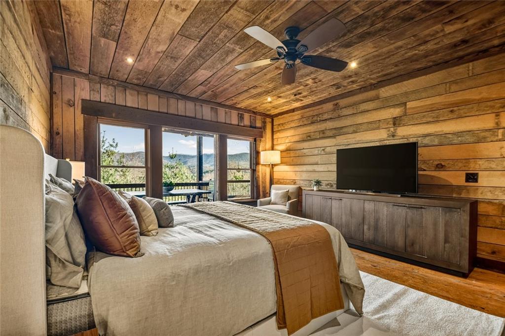 249 Settlement Road Epworth, GA 30541 - Photo 32 of 74 a bedroom with a bed and a flat screen tv