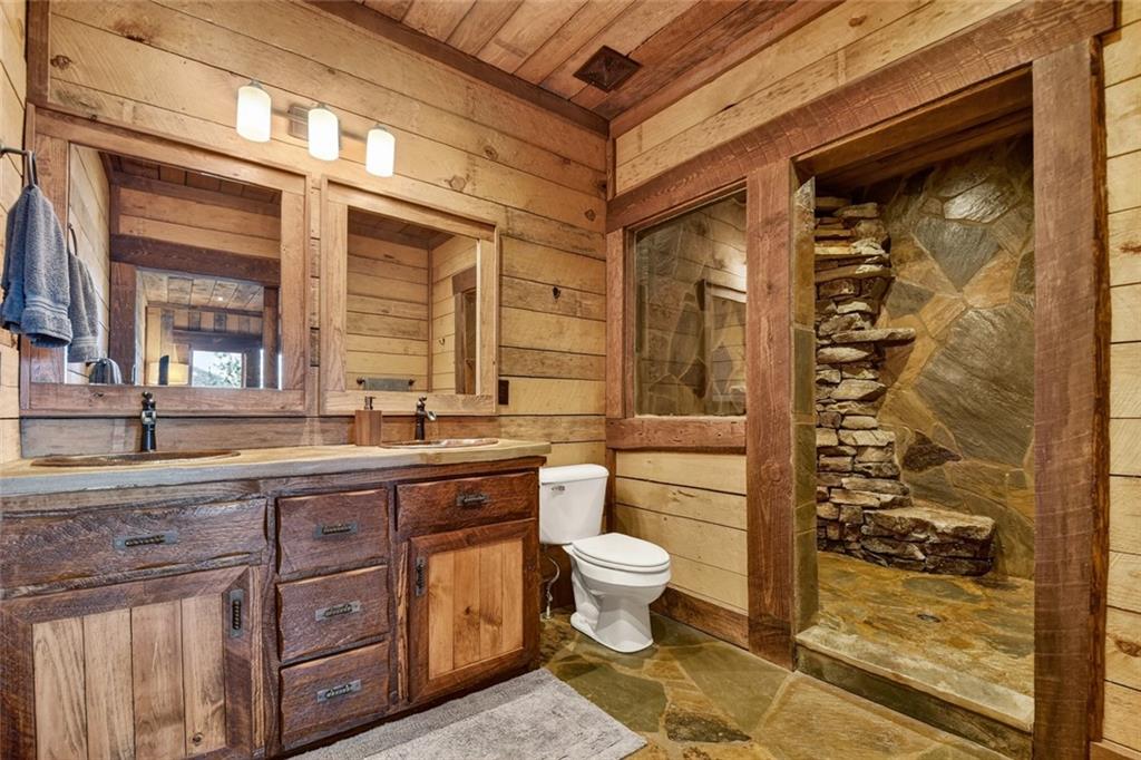 249 Settlement Road Epworth, GA 30541 - Photo 33 of 74 a bathroom with a granite countertop sink a toilet and shower
