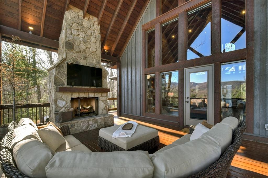 249 Settlement Road Epworth, GA 30541 - Photo 37 of 74 a outdoor living space with furniture a fireplace and a floor to ceiling window