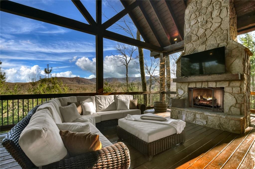 249 Settlement Road Epworth, GA 30541 - Photo 4 of 74 a living room with furniture a fireplace and a floor to ceiling window