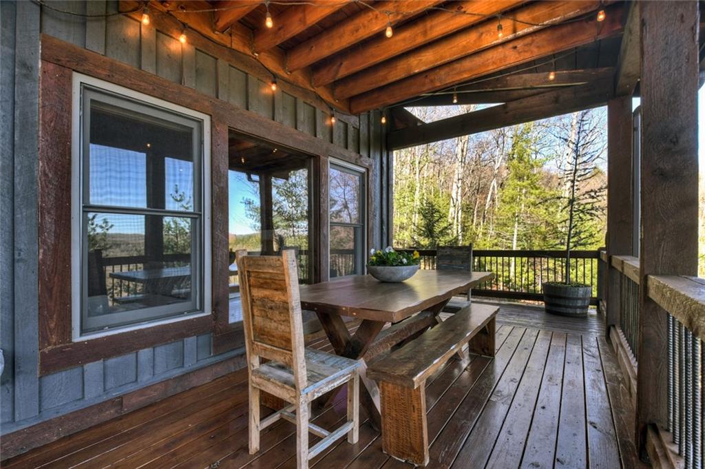 249 Settlement Road Epworth, GA 30541 - Photo 41 of 74 a view of a patio with table and chairs a wooden floor with a large window