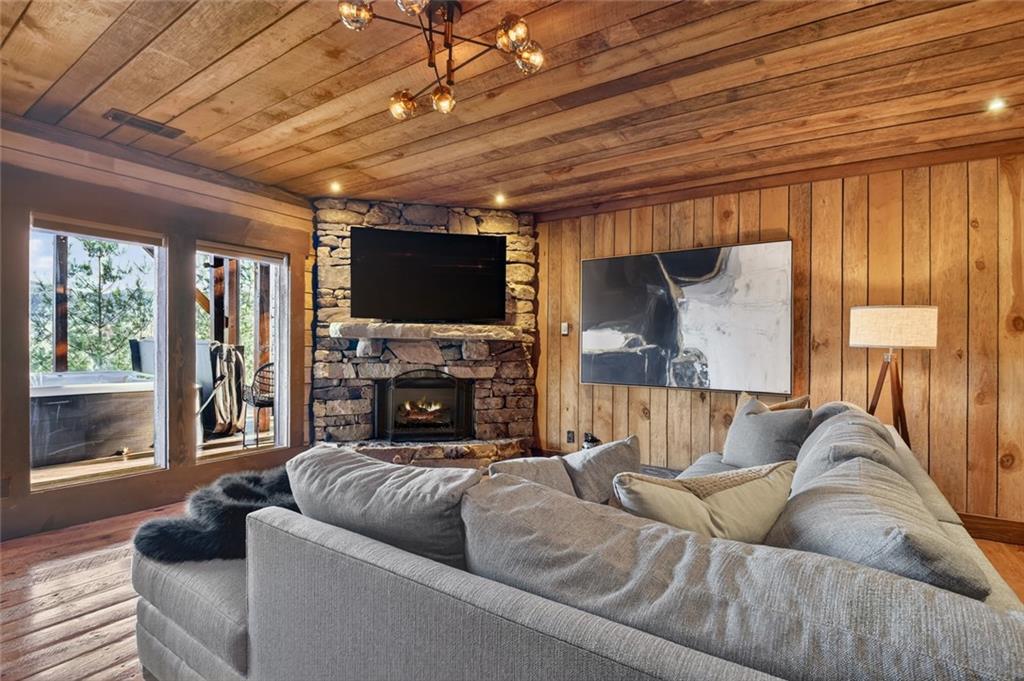 249 Settlement Road Epworth, GA 30541 - Photo 55 of 74 a living room with furniture a fireplace and a flat screen tv