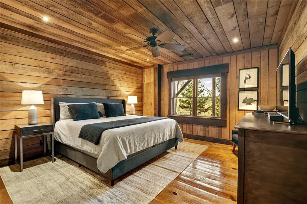 249 Settlement Road Epworth, GA 30541 - Photo 58 of 74 a bedroom with a large bed and a flat tv screen on dresser