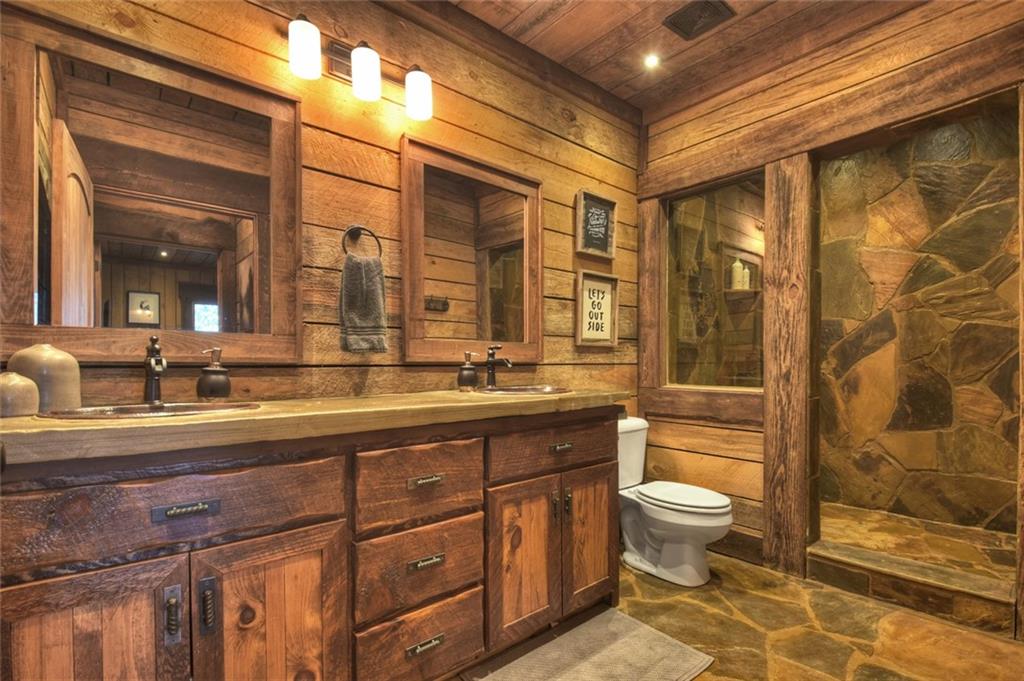 249 Settlement Road Epworth, GA 30541 - Photo 60 of 74 a bathroom with a double vanity sink toilet mirror and shower