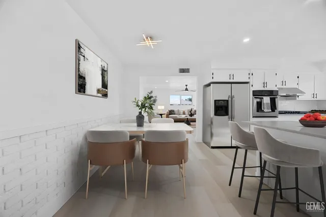 a dining room with furniture and kitchen view