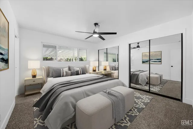 a bedroom with a bed a couch and a chandelier