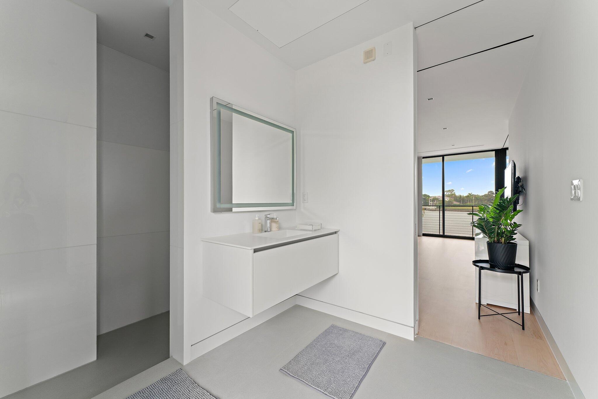 5706 Holly Lane Jupiter, FL 33458 - Photo 26 of 34 a room with a mirror and a sink