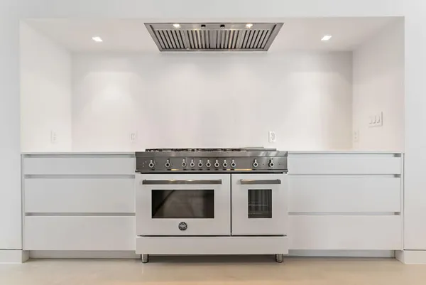 a kitchen with counter top space and living room
