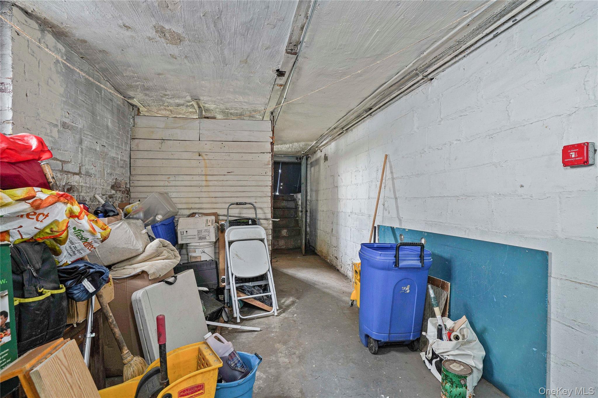 72-07 73rd Street Queens, NY 11385 - Photo 12 of 49 Below grade area featuring concrete block wall and a garage