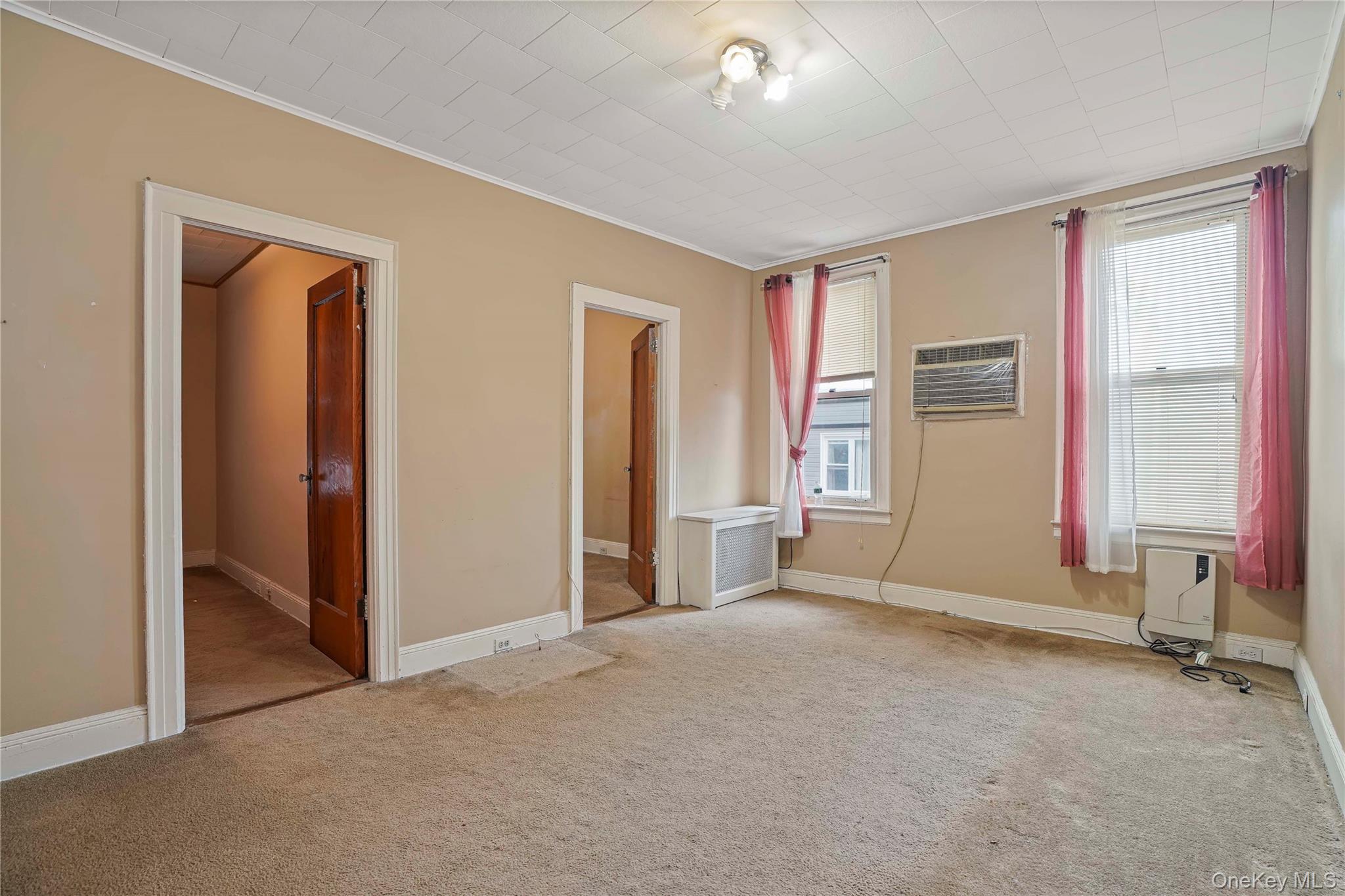 72-07 73rd Street Queens, NY 11385 - Photo 16 of 44 Unfurnished bedroom with crown molding, carpet, and a wall unit AC