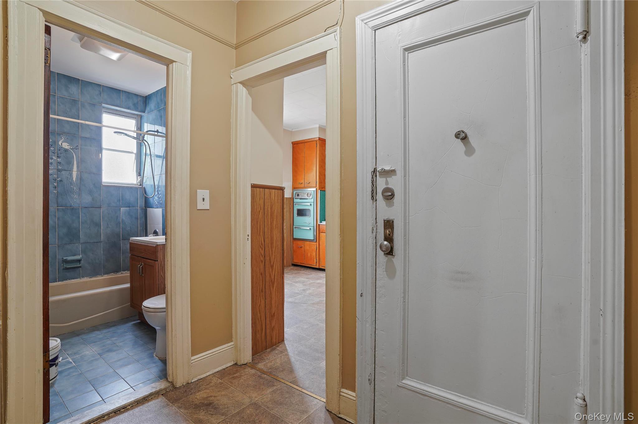 72-07 73rd Street Queens, NY 11385 - Photo 20 of 44 Full bathroom featuring shower combination, vanity, and dark tile patterned flooring