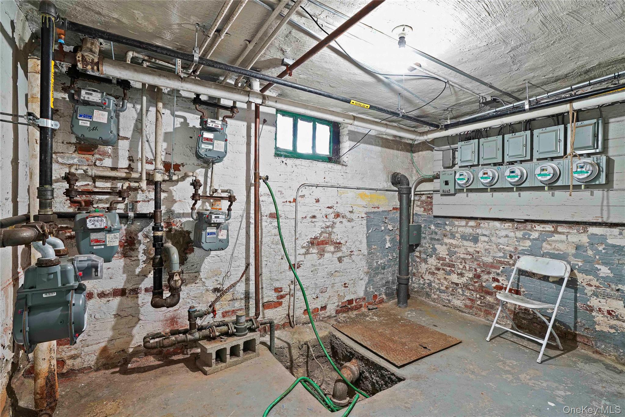 72-07 73rd Street Queens, NY 11385 - Photo 7 of 49 Utility room featuring electric panel