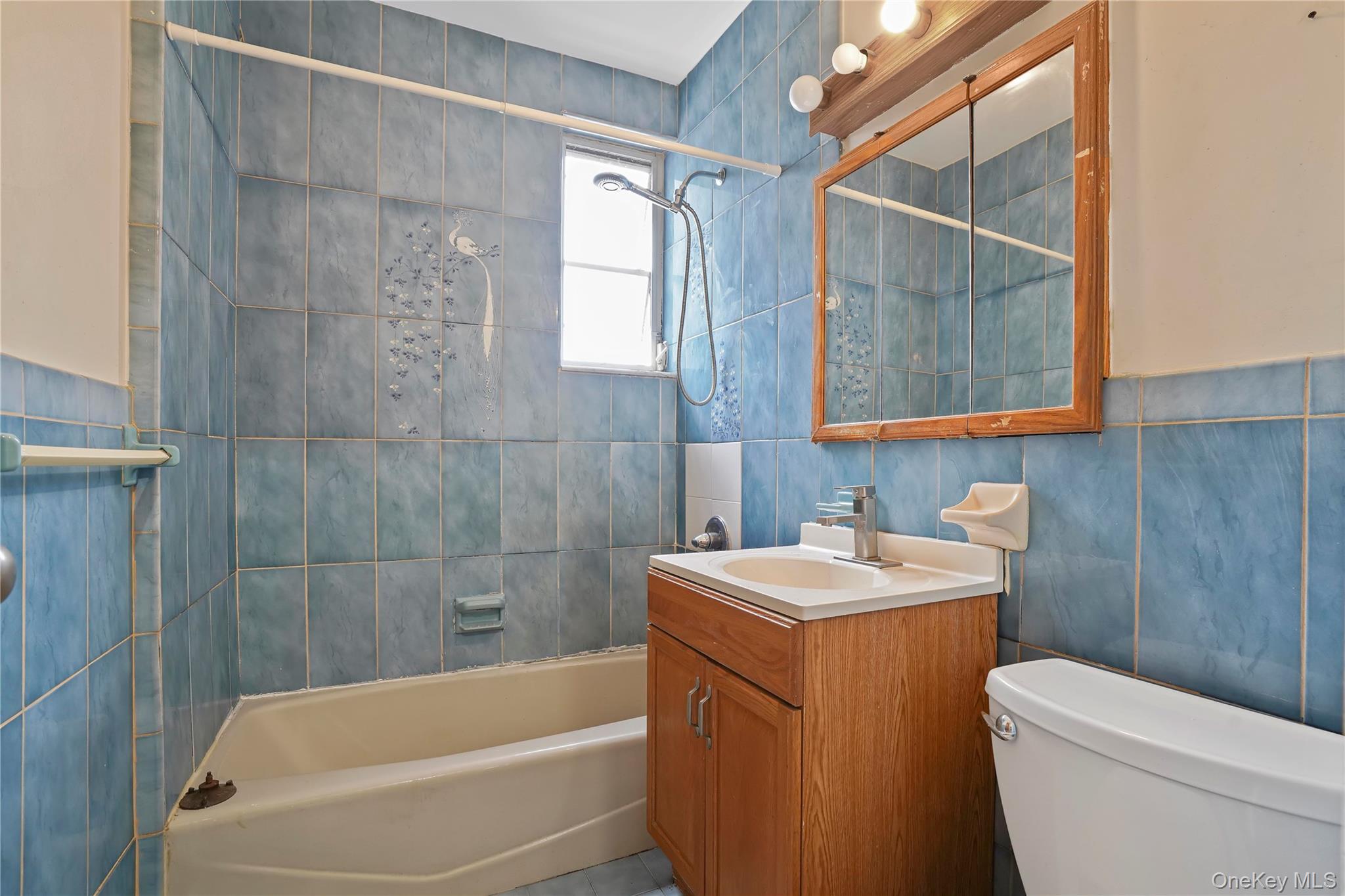 72-07 73rd Street Queens, NY 11385 - Photo 7 of 44 Full bathroom featuring tile walls, tub / shower combination, and vanity