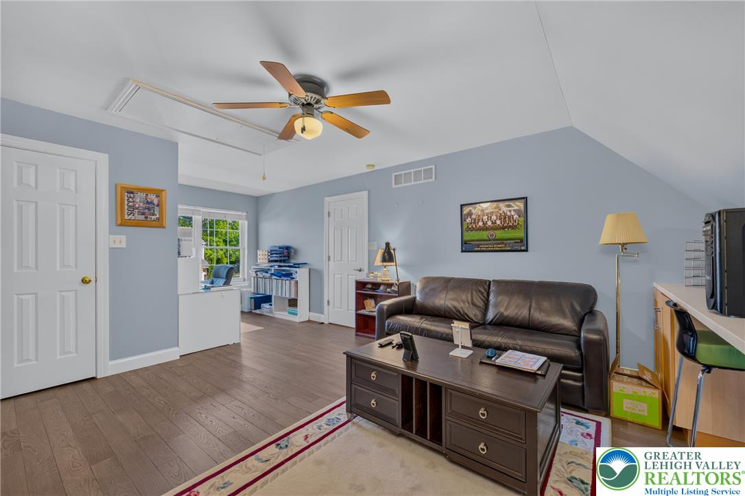 1702 Red Bud Road Quakertown, PA 18951 - Photo 51 of 68 An inviting office space features sloped ceilings and rich hardwood flooring, ready for productivity or relaxation.