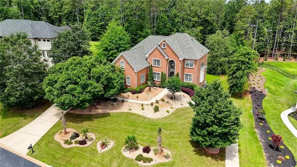 a aerial view of a house with swimming pool and big yard
