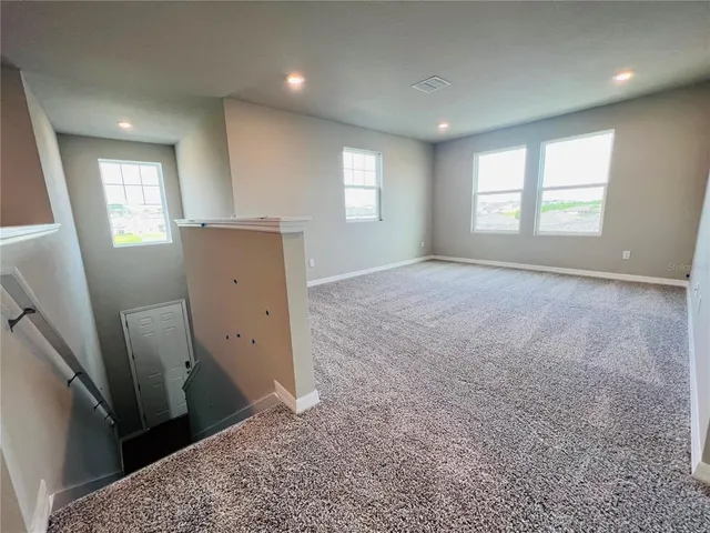 an empty room with windows and closet
