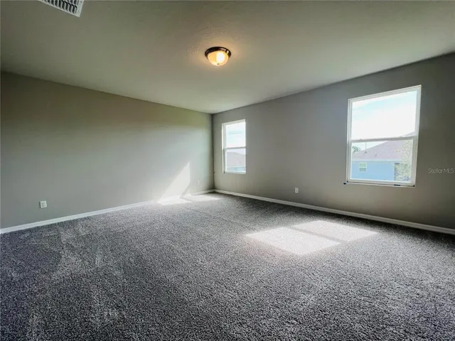 an empty room with a empty space and windows