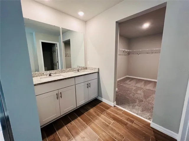 a bathroom with a double vanity sink and mirror