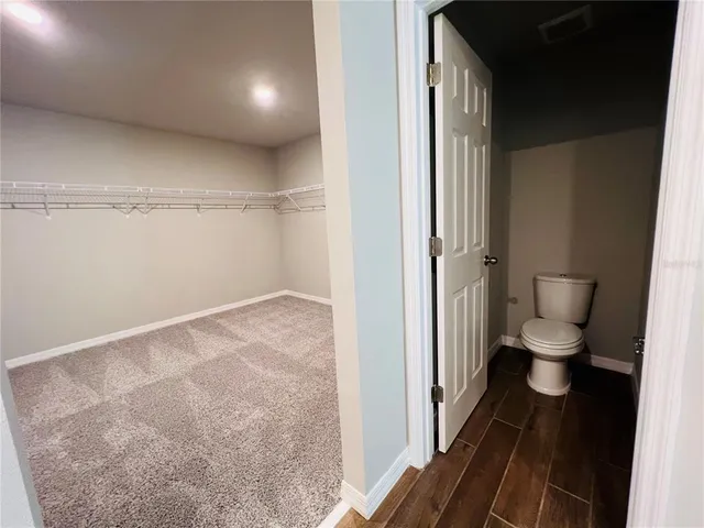 a view of an empty room and wooden floor