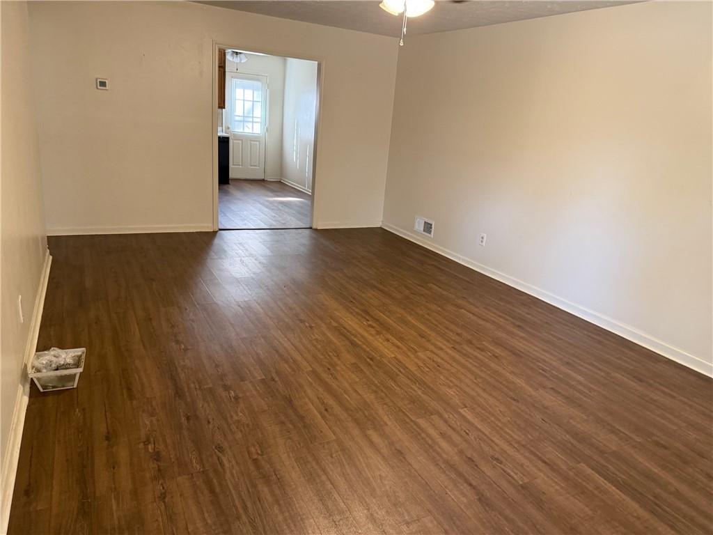 1085 Eastview Road Northeast Conyers, GA 30012 - Photo 2 of 14 wooden floor in an empty room