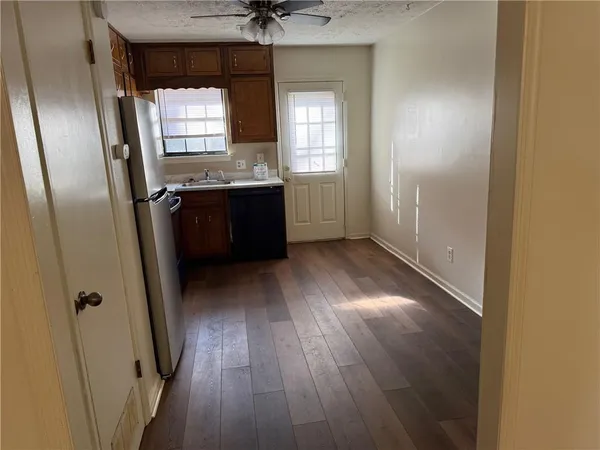 a view of hallway with a window and wooden floor