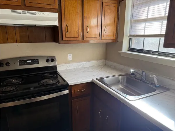 a kitchen that has a sink and a stove