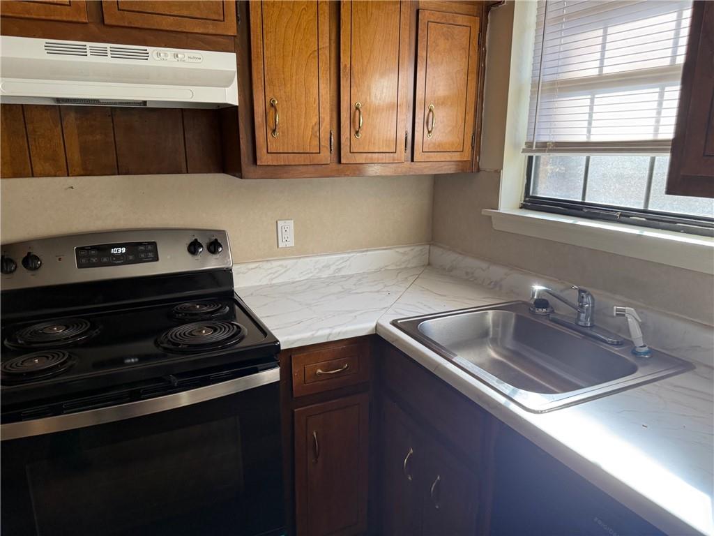 1085 Eastview Road Northeast Conyers, GA 30012 - Photo 4 of 14 a kitchen that has a sink and a stove