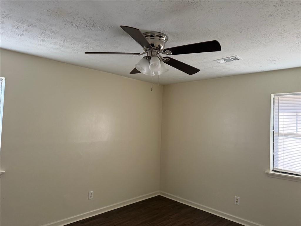 1085 Eastview Road Northeast Conyers, GA 30012 - Photo 7 of 14 an empty room with a window and a fan