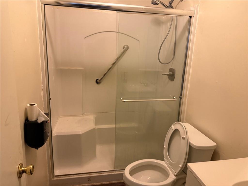 1085 Eastview Road Northeast Conyers, GA 30012 - Photo 8 of 14 a bathroom with a toilet and a shower