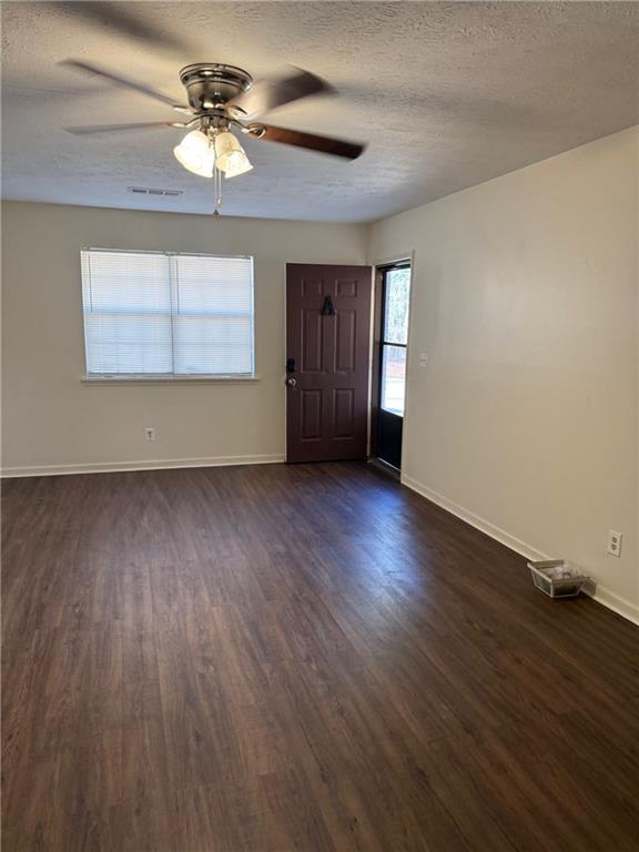 1085 Eastview Road Northeast Conyers, GA 30012 - Photo 10 of 14 a view of an empty room with wooden floor and a window