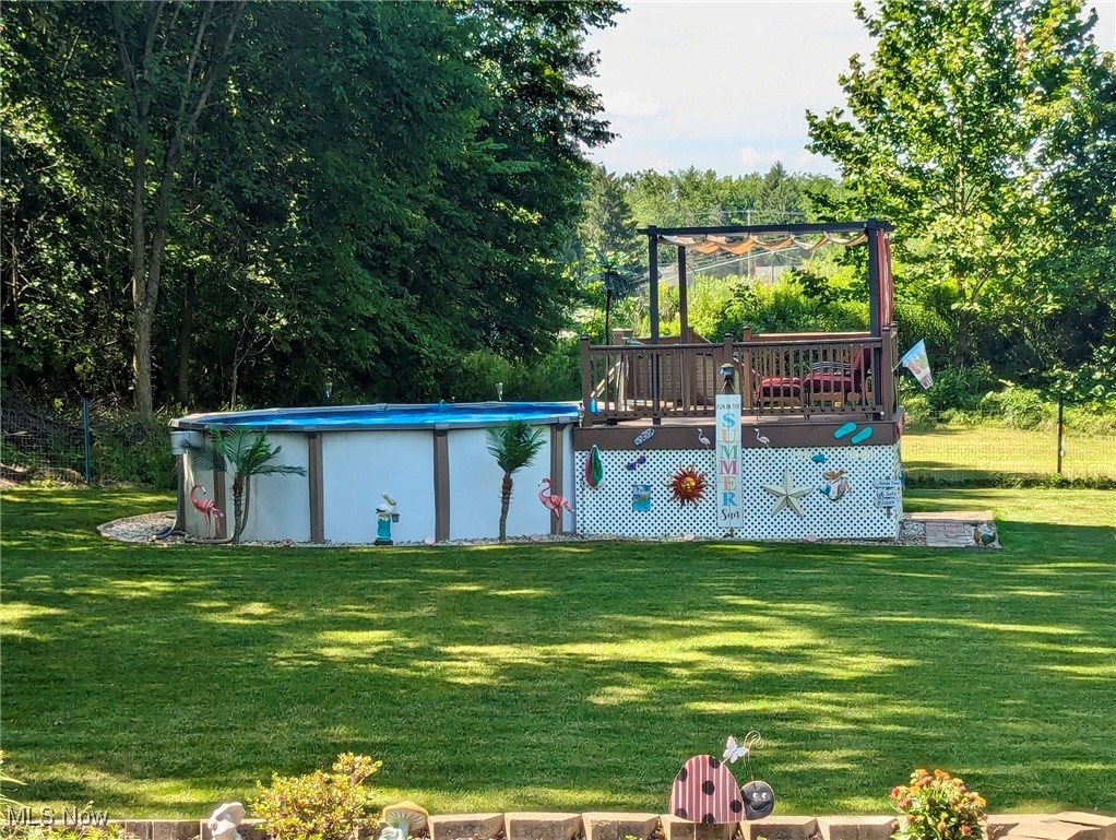 240 Spring Creek Road Northfield, OH 44067 - Photo 35 of 39 View of swimming pool featuring a yard and a wooden deck