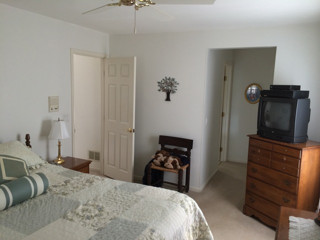 1241 Telegraph Road Lake Forest, IL 60045 - Photo 5 of 10 a bedroom with a bed and a flat tv screen on dresser