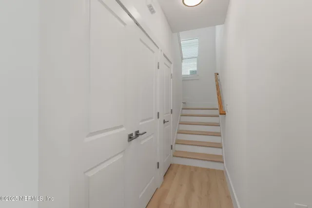 a view of a hallway with stairs