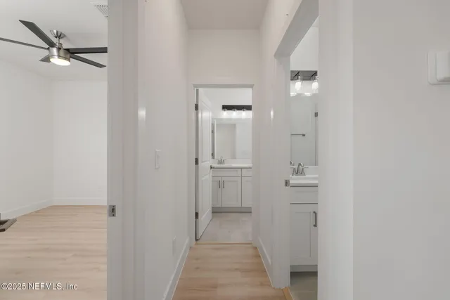 a view of a hallway with a closet and a mirror