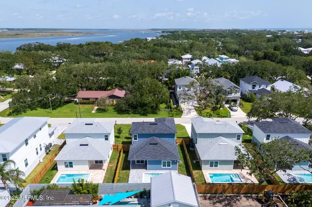 an aerial view of residential houses with outdoor space