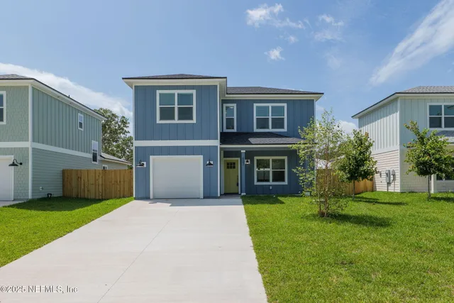 a front view of house with yard and green space