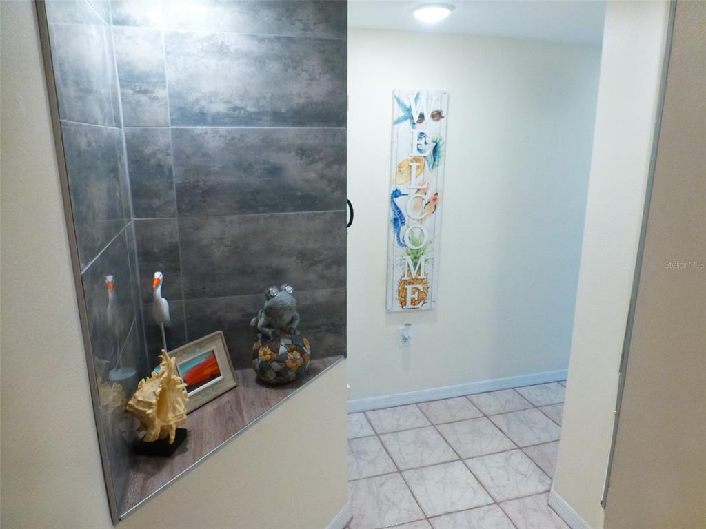 5557 Sea Forest Drive, Unit 215 New Port Richey, FL 34652 - Photo 22 of 42 a bathroom with a sink and a vanity