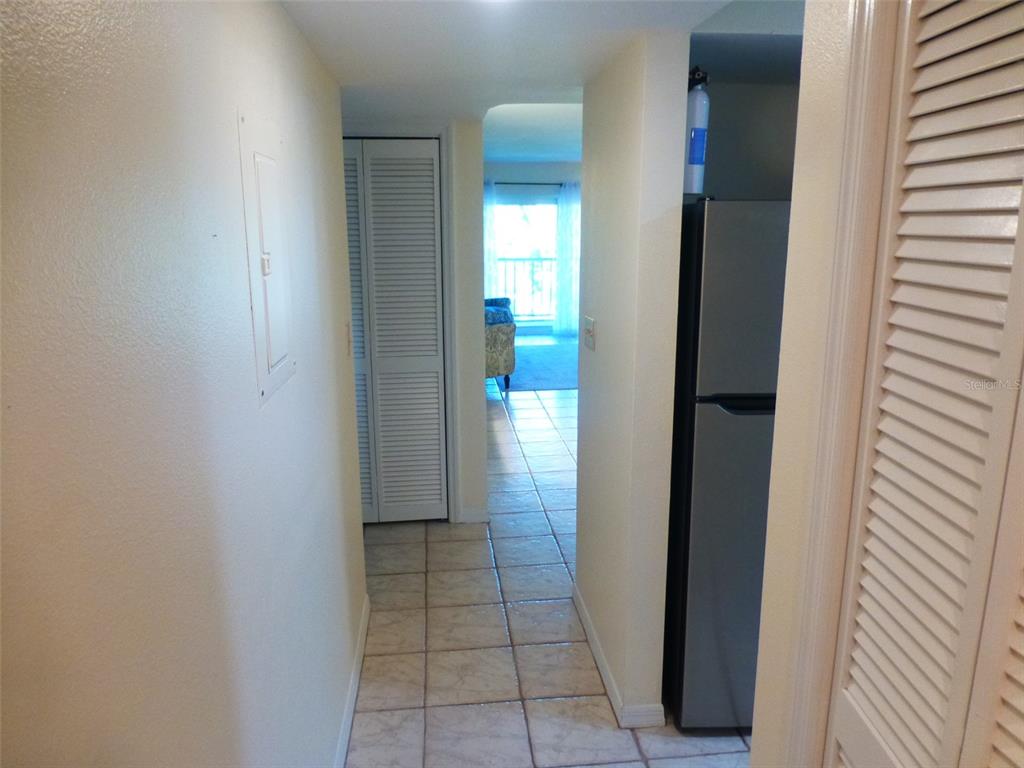 5557 Sea Forest Drive, Unit 215 New Port Richey, FL 34652 - Photo 23 of 42 a view of a hallway with wooden floor and a bathroom