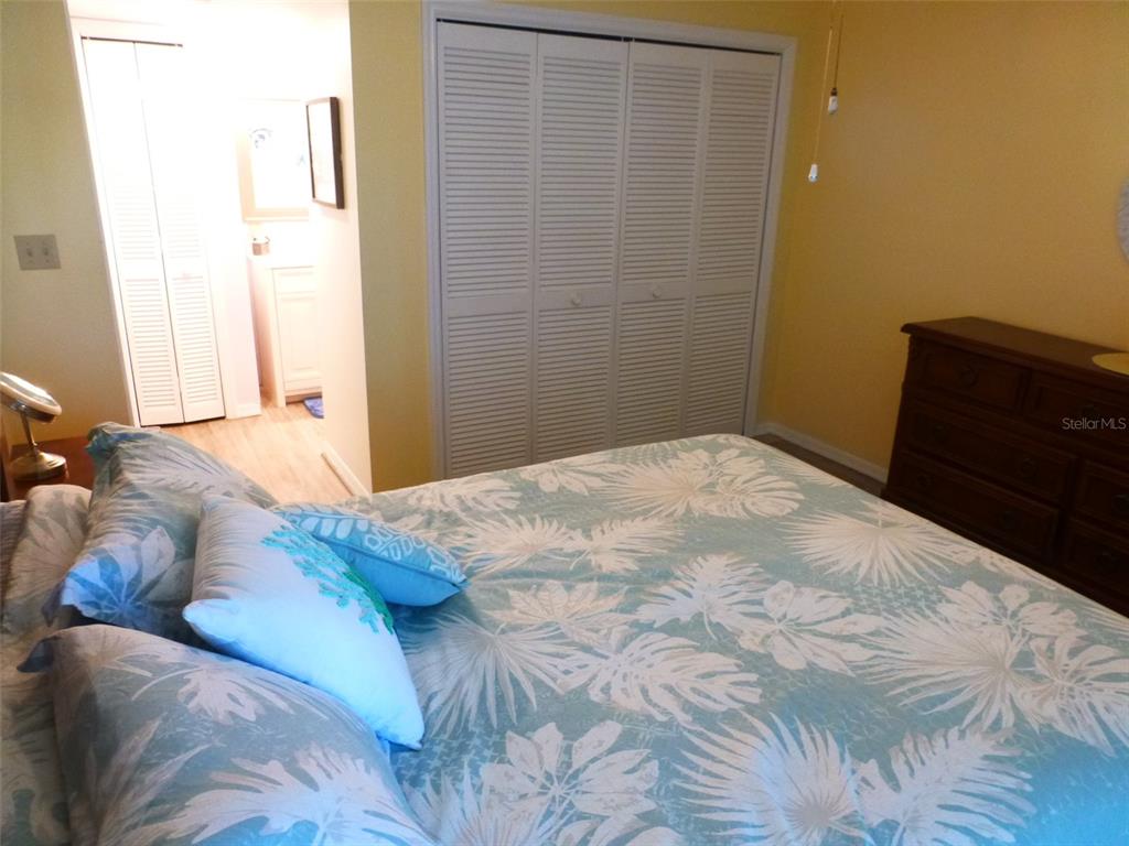 5557 Sea Forest Drive, Unit 215 New Port Richey, FL 34652 - Photo 27 of 42 a bedroom with a bed and a dresser