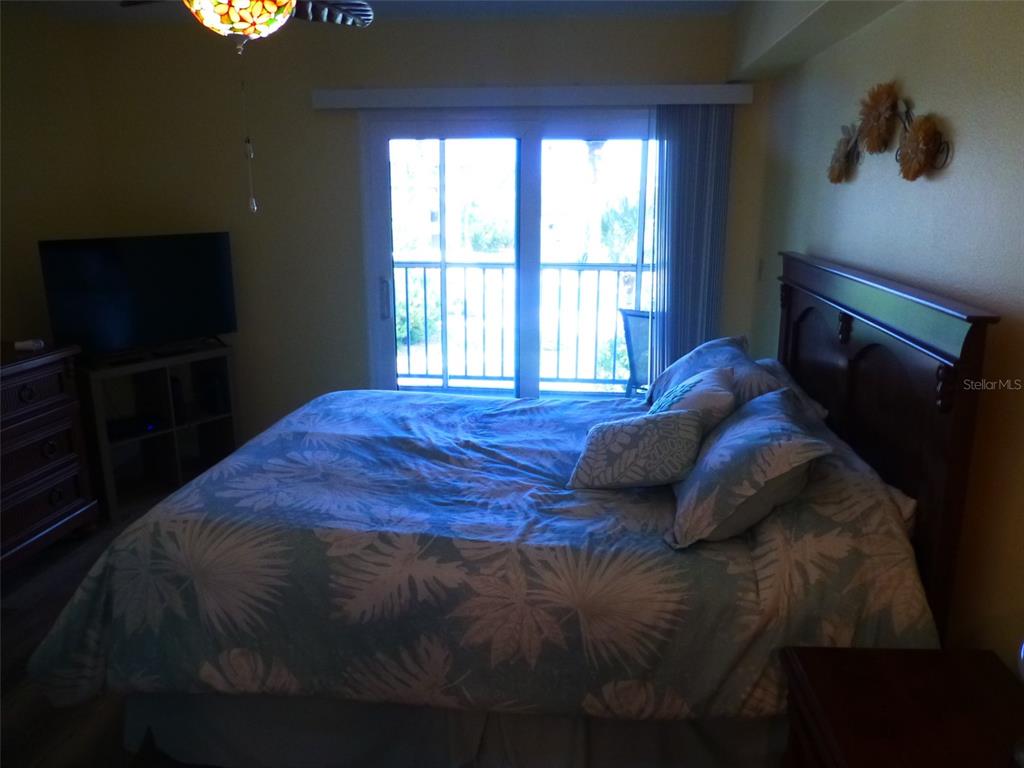 5557 Sea Forest Drive, Unit 215 New Port Richey, FL 34652 - Photo 28 of 42 a bedroom with a bed and a window