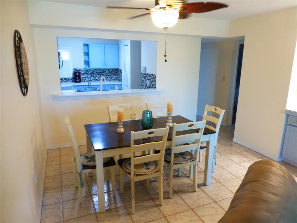 5557 Sea Forest Drive, Unit 215 New Port Richey, FL 34652 - Photo 29 of 42 a view of a dining room with furniture