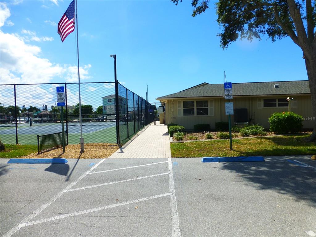 5557 Sea Forest Drive, Unit 215 New Port Richey, FL 34652 - Photo 37 of 42 a view of a house with swimming pool and a yard