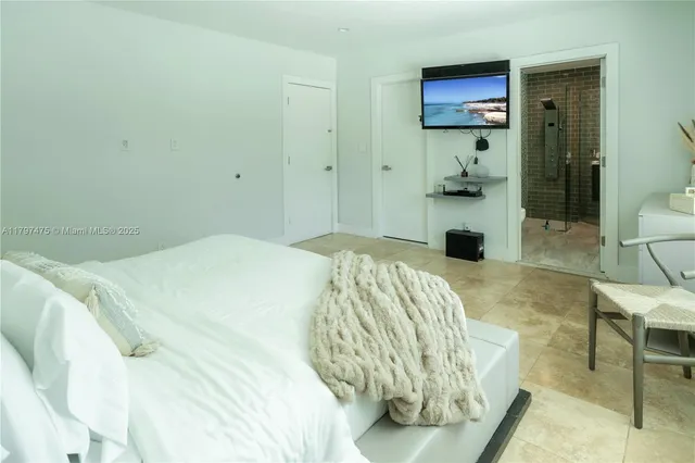 a bedroom with a bed and a view of bathroom