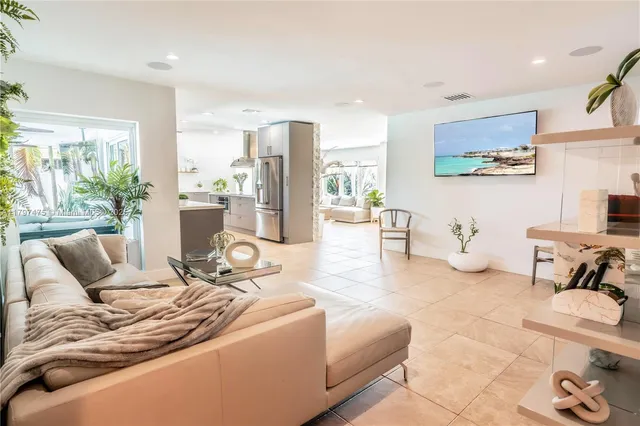a living room with furniture and a floor to ceiling window