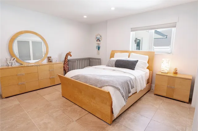 a bedroom with a bed and a dresser