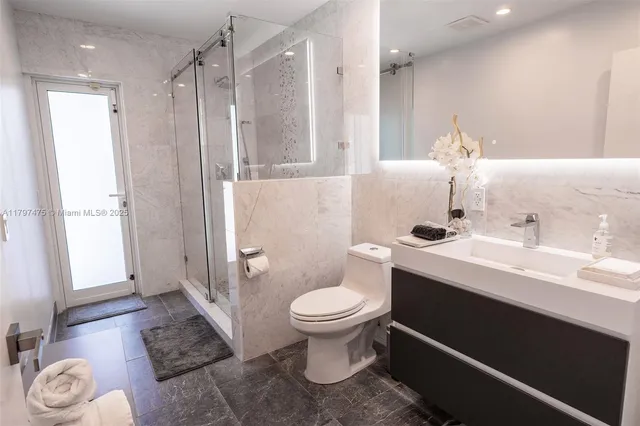 a bathroom with a sink toilet and shower
