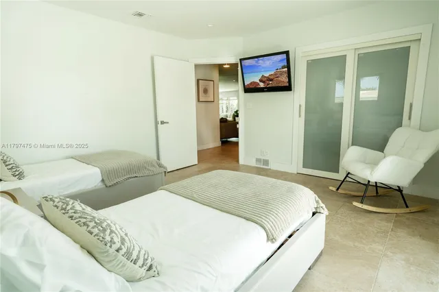 a bedroom with a bed and a chair