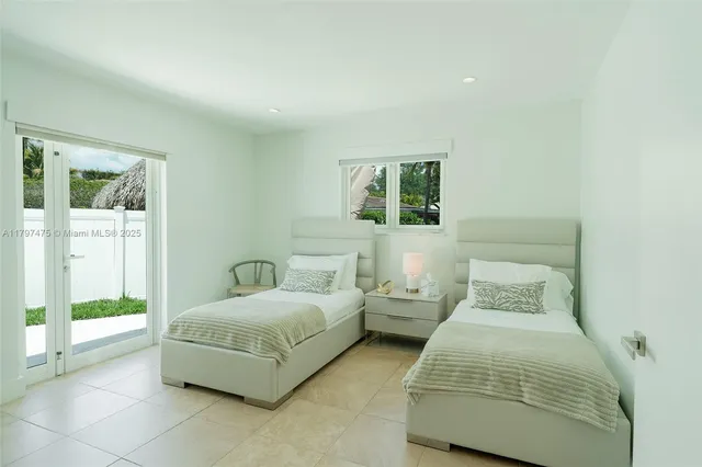 a bedroom with a bed and large window