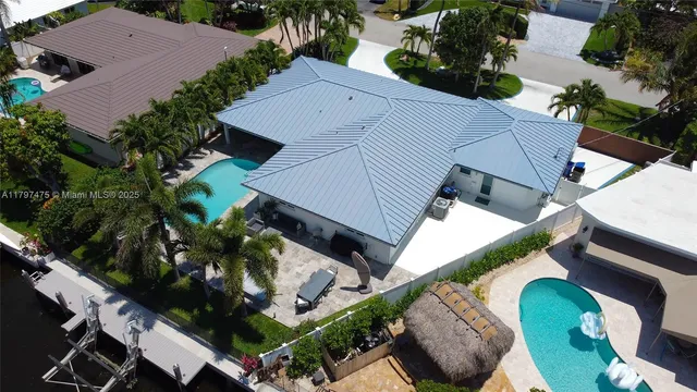 an aerial view of a house with a yard and plants